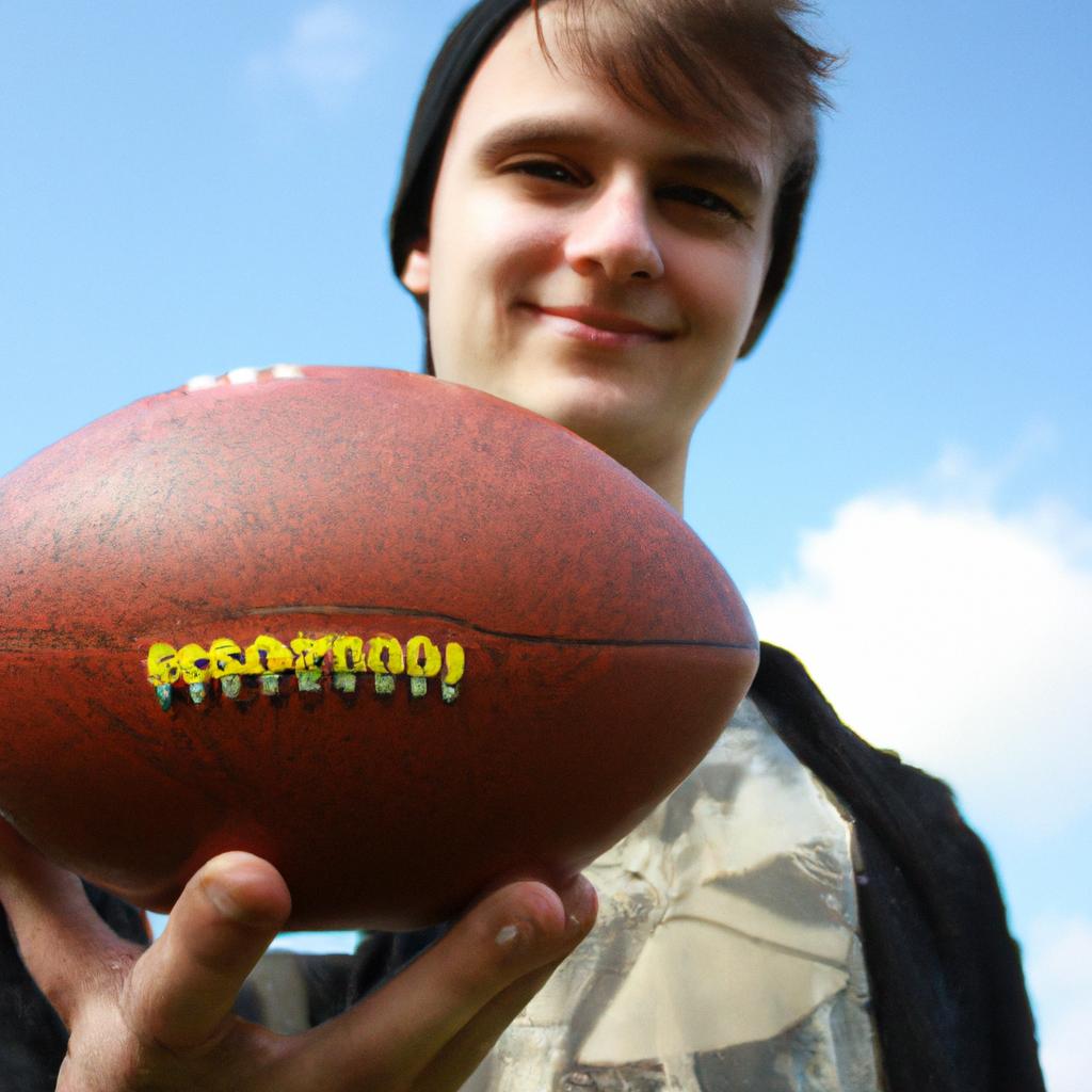 Person holding a football, smiling