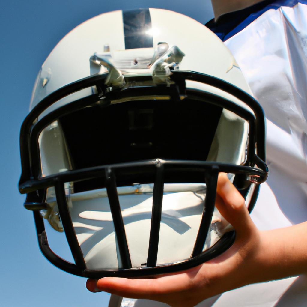 Person holding a football helmet