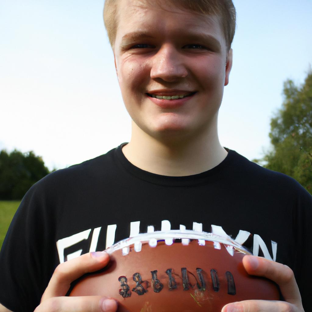 Person holding a football, smiling